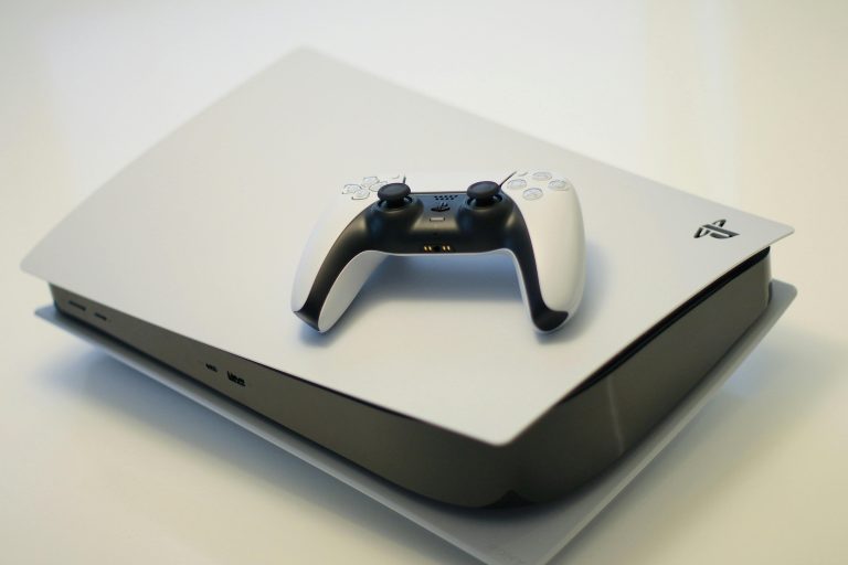 A sleek gaming console with a compatible controller, ideal for tech enthusiasts.